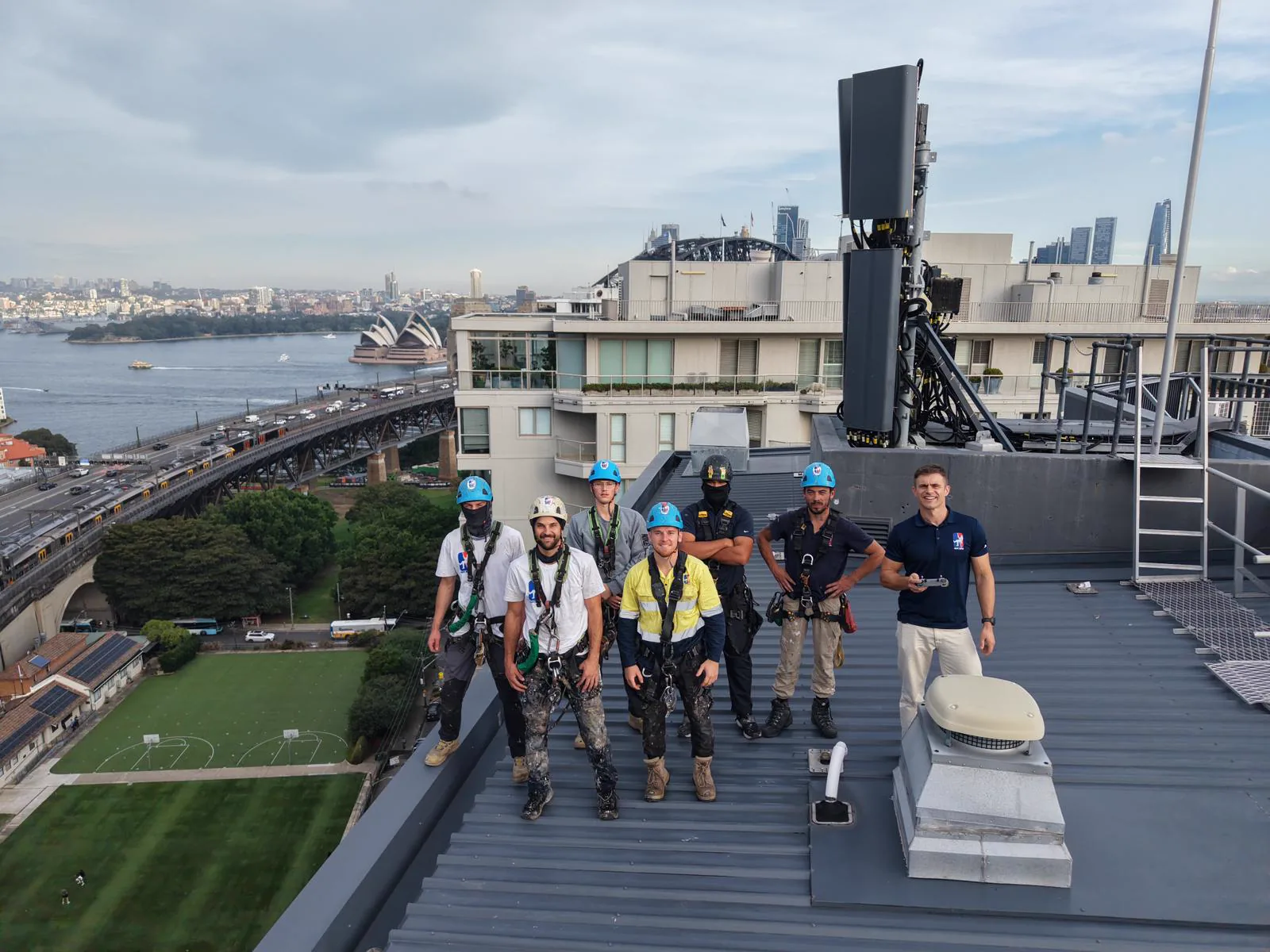 Rope Boys IRATA rope access technicians on a Milsons Point rooftop above Sydney Harbour